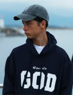Sudadera azul con capucha para hombre y mujer. Algodón 100%. Con el mensaje “All you need is God”. Producto solidario de Have a God Time